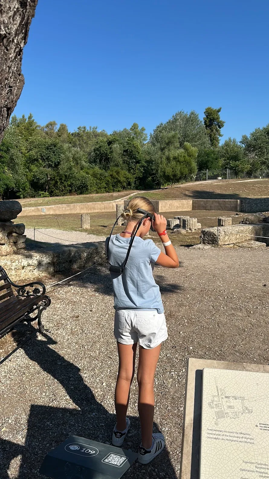 A child looking through the VR glasses at the ruins of Olympia